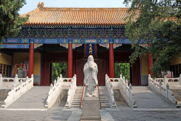 The statue of Confucius stands in front of the gate of Confucius Temple in Beijing, China. stock photo