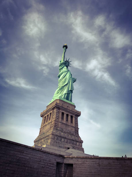 The Statue of Liberty pointing toward sky stock photo