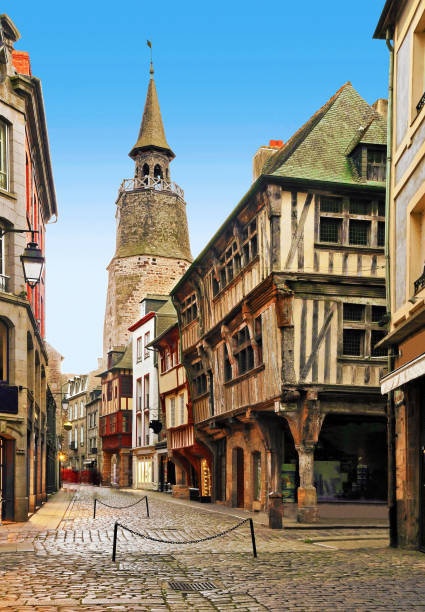 The street clock in Dinan in Brittany, France Picturesque street of Dinan with houses of the Middle Ages, in the department of Côtes-d'Armor. brittany france stock pictures, royalty-free photos & images