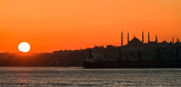 The sun sets over the horizon over the Bosphorus stock photo