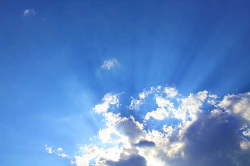 The sun's rays appear through the clouds. Close-up. Background. Landscape.