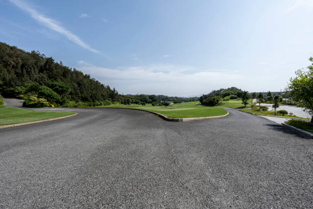The tarmac road by the golf course stock photo