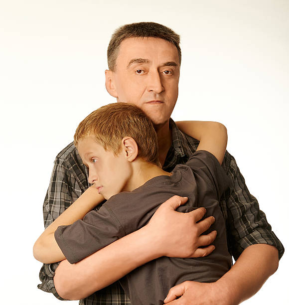 The ten years' son and father embrace each other stock photo