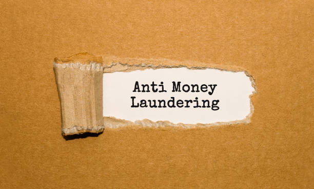 The text Anti Money Laundering appearing behind torn brown paper The text Anti Money Laundering appearing behind torn brown paper money laundering stock pictures, royalty-free photos & images