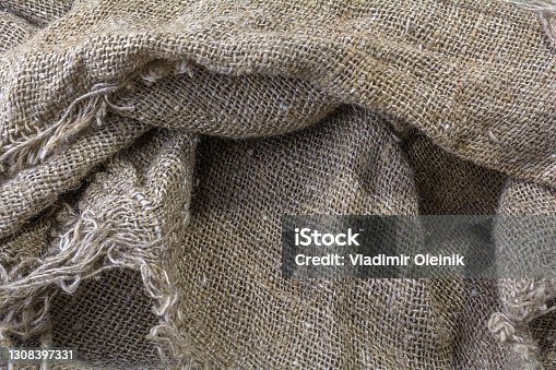 istock The texture of the burlap. Natural aged linen texture with creases and shadows. 1308397331