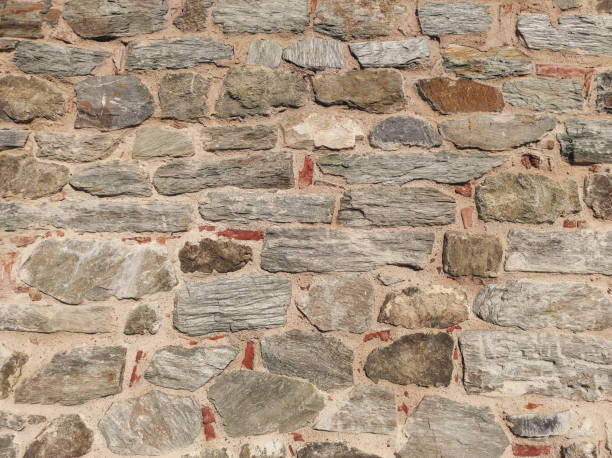 The texture of the original stone wall of the medieval fortress stock photo