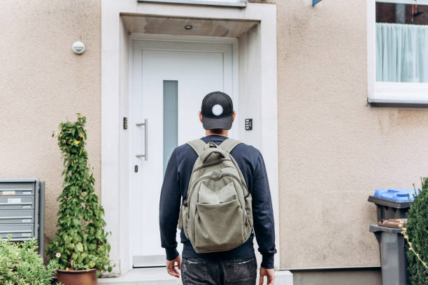 The tourist or the student with the backpack. A tourist goes to the guesthouse or hostel in order to stay in a room that he booked. returning home stock pictures, royalty-free photos & images