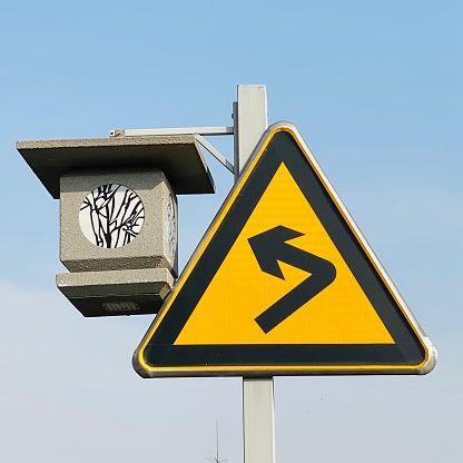 The traditional style street light and yellow traffic sign