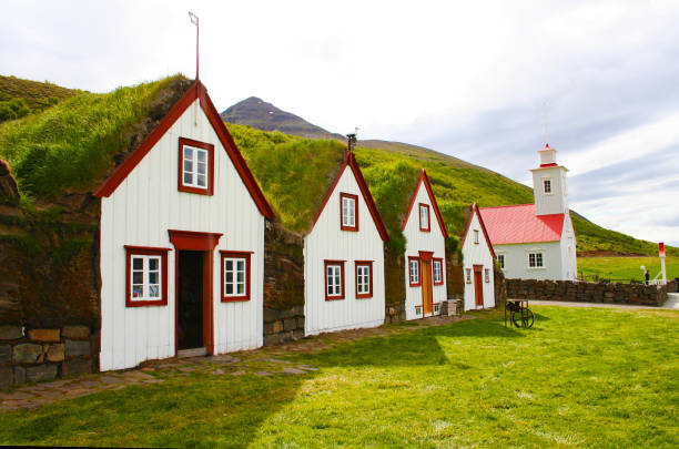 The turf farmhouse and the church in Laufas (Akureyri, Iceland) stock photo