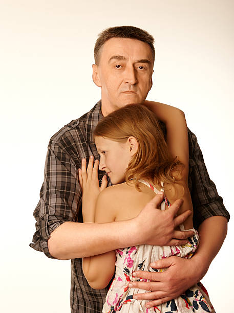 The twelve years daughter hugging father stock photo