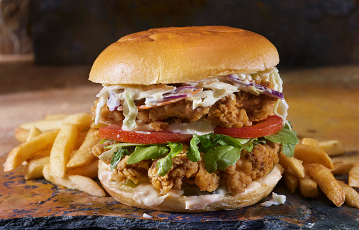 The Ultimate Double Spicy Crispy Fried Chicken Burger with Pickles,  Arugula, Tomatoes, Creamy Coleslaw and French Fries