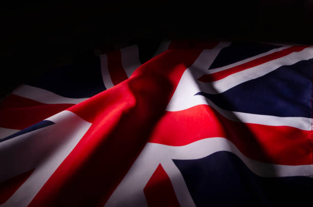 The Union Jack flag of Great Britain in shadow stock photo