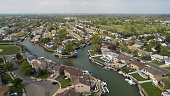 istock The wealth residential district in Oceanside, Queens, New York City, with houses with pools on backyards and piers with boats along the channels. 1152531401