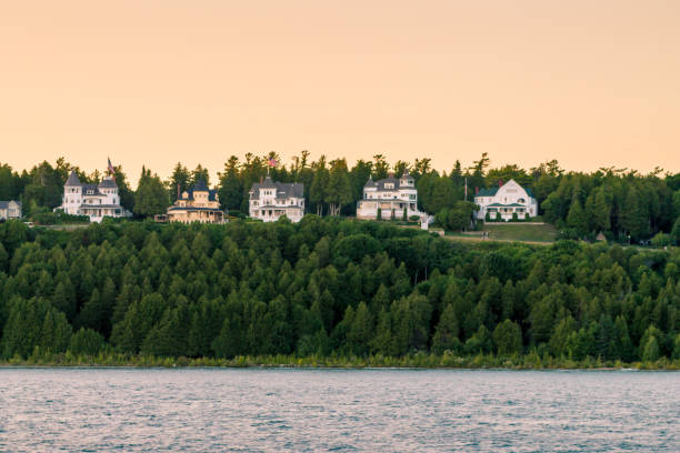 The West bluff of Mackinac island at sunset from a ferry boat stock photo