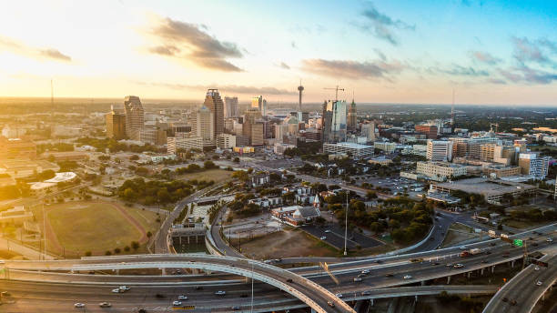 The whole city of San Antonio taken from a drone while its sunrise The image incompasses the whole city of San Antonio, including all of its landmarks and highways, and has a sun flare from the left while contrasting is a blue front from the right san antonio stock pictures, royalty-free photos & images
