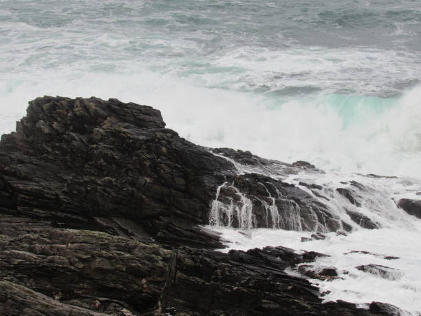 The Wild Atlantic Way Waves crashing against the rocks at Malin Head, Co.Donegal. inishowen peninsula stock pictures, royalty-free photos & images