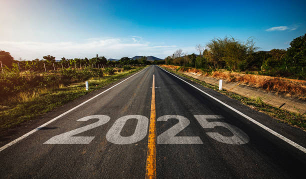 The word 2025 written on highway road in the middle of empty asphalt road stock photo