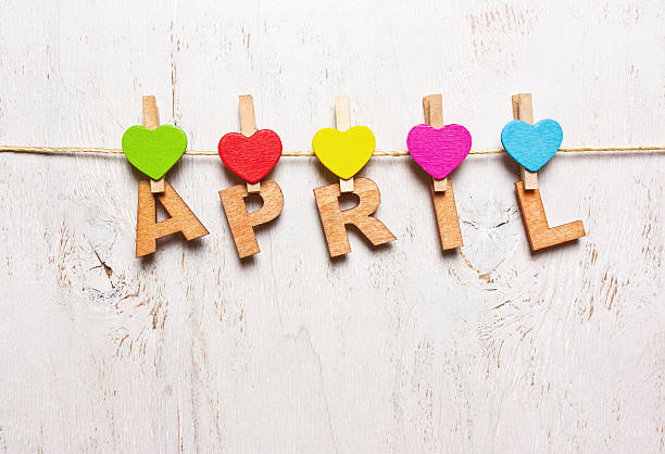the word "april" from the wooden letters the word "april"  letters on a wooden clothespins on a white background old april stock pictures, royalty-free photos & images