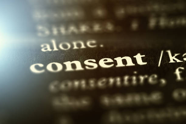 The word "consent" highlighted on a printed page stock photo