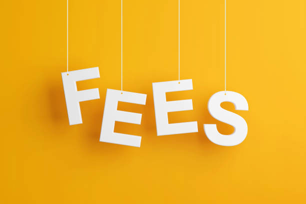 The word fees levitates on yellow background. stock photo