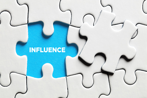 The word influence on a missing puzzle piece. Business concept.