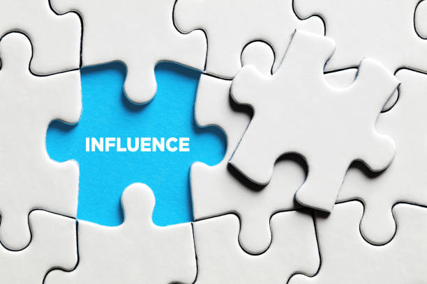 The word influence on a missing puzzle piece. stock photo