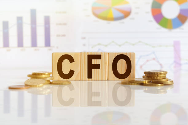 CFO the word on wooden cubes, cubes stand on a reflective surface, in the background is a business diagram. CFO the word on wooden cubes, cubes stand on a reflective surface, in the background is a business diagram. Business and finance concept cfo stock pictures, royalty-free photos & images