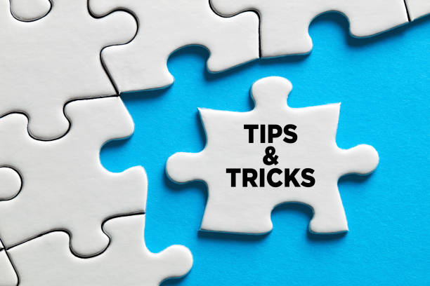 The word tips and tricks on a puzzle piece. stock photo