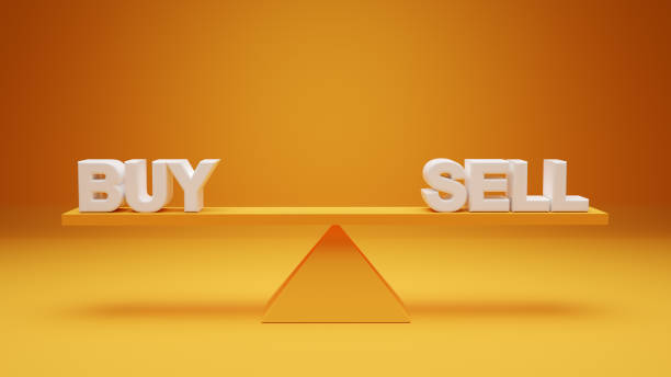 The words buy and sell are balanced on a seesaw. Buying or selling decision or dilemma stock photo