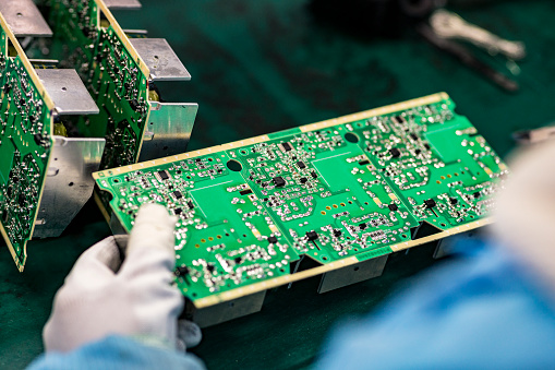 The worker operating to Assemble Printed Circuit Board for  electrical appliances at a electronics factory,china.