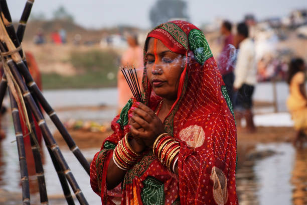 The worship. A devotee worshiping Sun God on the occasion of Chhath festival ,India. chhath stock pictures, royalty-free photos & images