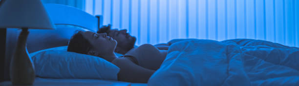 The young couple relax in the bed. night time stock photo