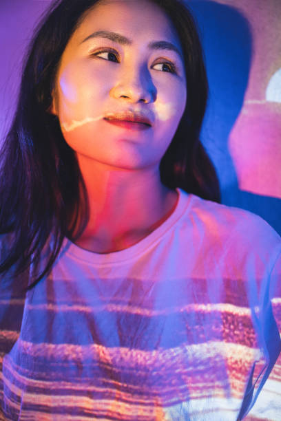 The young woman in white was illuminated by red lights stock photo