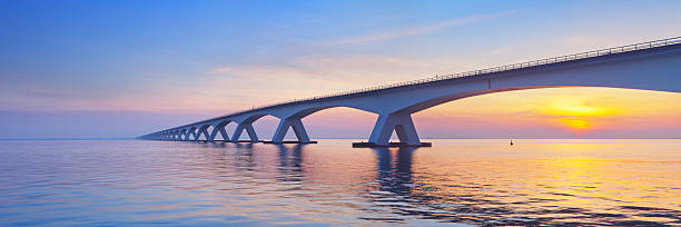 the zeeland bridge in zeeland, the netherlands at sunrise - zeeland stockfoto's en -beelden