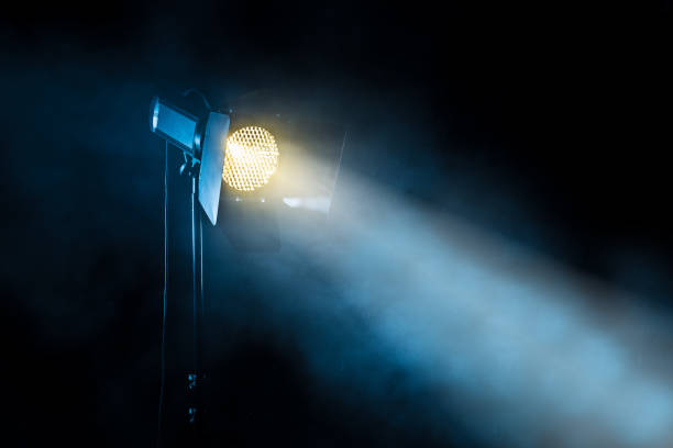 Theater spot light on black background Theater spot light on black background with smoke staging light stock pictures, royalty-free photos & images