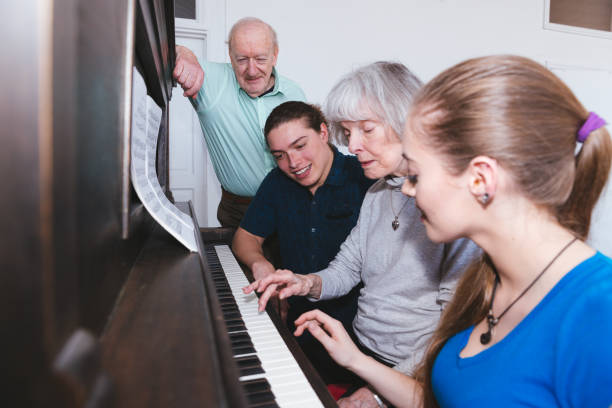 There is no age for learning - Family Playing Piano stock photo