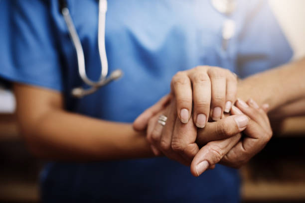 There to offer guidance Cropped shot of an unrecognizable female nurse holding a senior woman's hands in comfort patience stock pictures, royalty-free photos & images