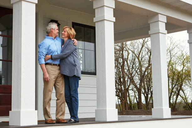 There's no place like home Shot of a happy mature couple standing on the doorstep of their home home insurance stock pictures, royalty-free photos & images