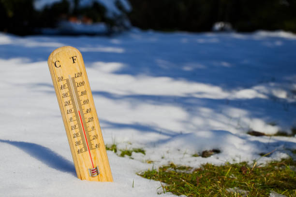 thermometer in melting snow, spring is coming temperature measurement in spring time, ending winter fahrenheit stock pictures, royalty-free photos & images