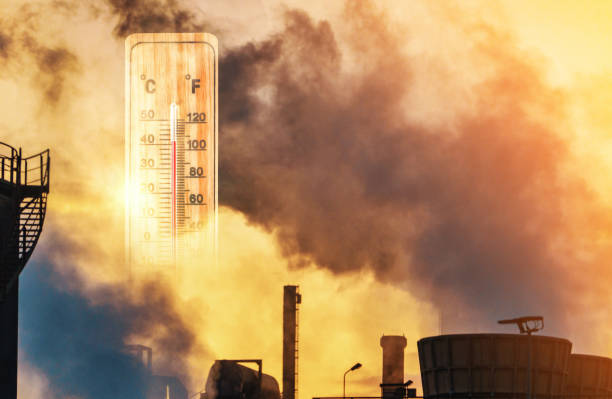 Thermometer in the heat and the exhaust of the industry shows high values for global warming Kopie stock photo