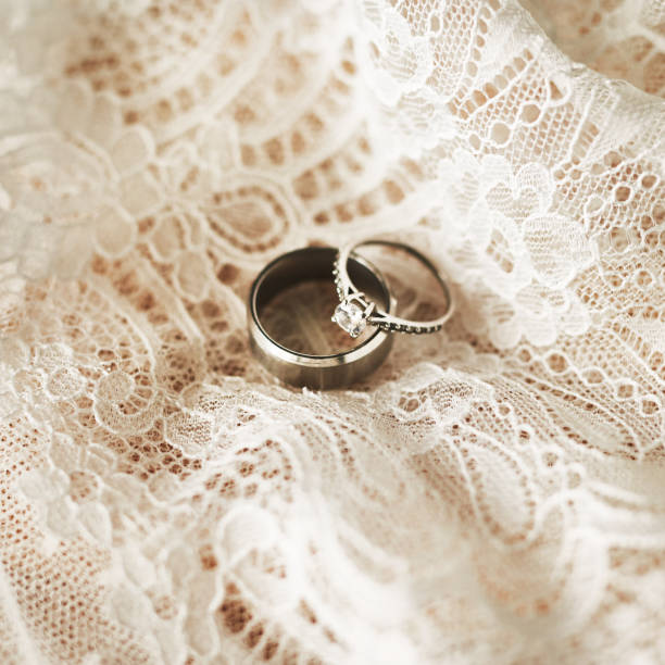 These rings will unify our hearts forever Still life shot of two beautiful wedding rings on top of a wedding dress wedding ring box stock pictures, royalty-free photos & images