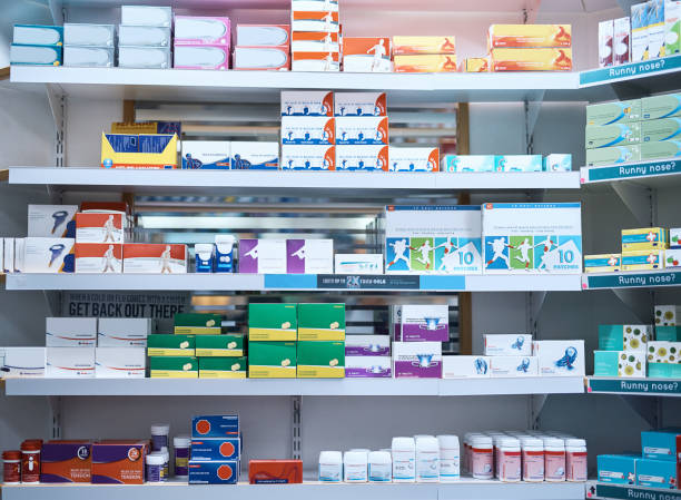 They've got your medicine covered Shot of shelves stocked with various medicinal products in a pharmacy aisle photos stock pictures, royalty-free photos & images
