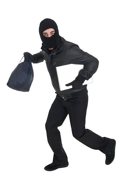 Thief dressed in black running Please see some other pictures from my portfolio: ski mask criminal stock pictures, royalty-free photos & images
