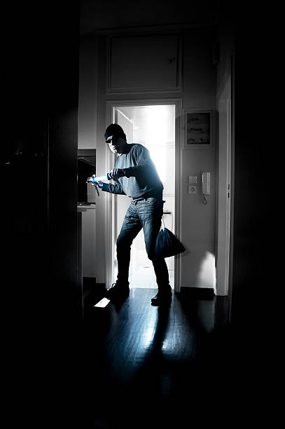 Thief in a house stock photo