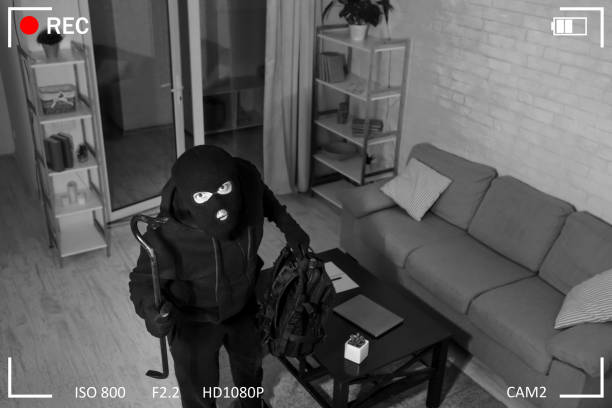Thief With Crowbar Entering House View From Camera Being Caught. Robber entering house, holding crowbar and looking at CCTV camera, high angle view from above burglar alarm stock pictures, royalty-free photos & images