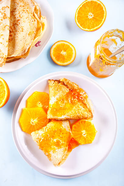 Thin pancakes crepes with orange fruit and sweet sauce marmalade stock photo