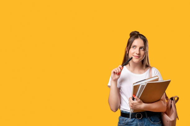 think idea student lifestyle puzzled woman Think idea. Student lifestyle. Puzzled woman with notebooks and backpack isolated on orange copy space. Doubt face. New project. Advertising background student stock pictures, royalty-free photos & images