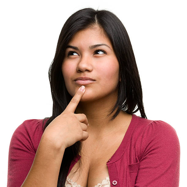 Thinking Young Woman Looks Up Portrait of a young woman on a white background. http://s3.amazonaws.com/drbimages/m/ja.jpg hand on chin stock pictures, royalty-free photos & images