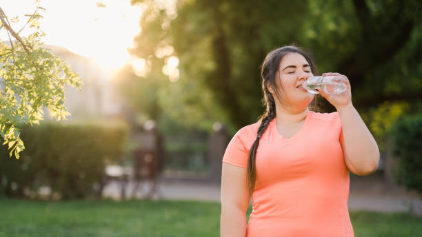 thirst reduce healthy well-being overweight woman stock photo