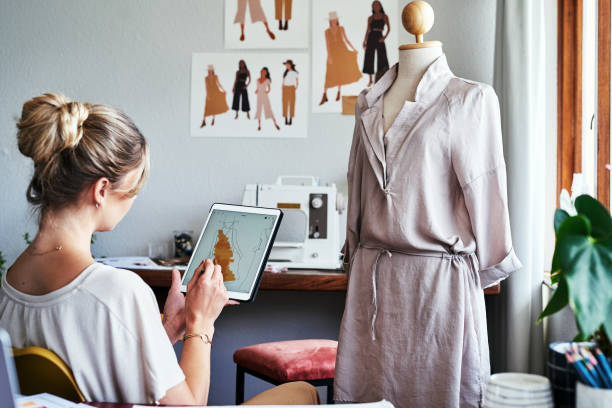 This design just inspired me to do a short sleeve dress Cropped shot of a fashion designer using a digital tablet to create new designs fashion design sketches stock pictures, royalty-free photos & images